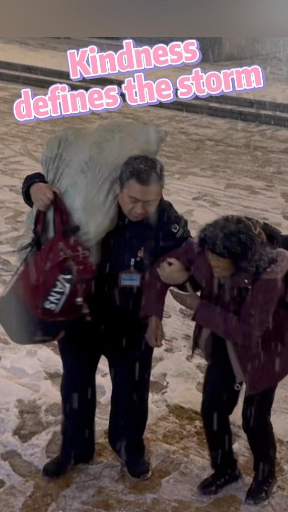 Railway worker helps elderly passenger in snow